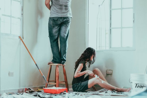 two people painting a room in their house 